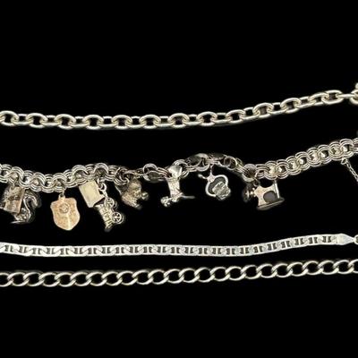 Sale Photo Thumbnail #797: **WIRE TRANSFER IS REQUIRED IF SHIPPED.** [67.94g] Includes a charm bracelet, and three various style curb link bracelets. The clasps are intact. Age related wear. Measurement of longest: 8”. Silver content confirmed using Niton XRF precious metals anal
