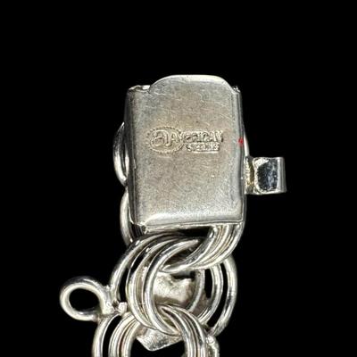 Sale Photo Thumbnail #799: **WIRE TRANSFER IS REQUIRED IF SHIPPED.** [67.94g] Includes a charm bracelet, and three various style curb link bracelets. The clasps are intact. Age related wear. Measurement of longest: 8”. Silver content confirmed using Niton XRF precious metals anal