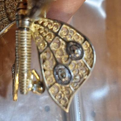 Sale Photo Thumbnail #1384: We can't find the marking for sterling but did find the AC marking.  This brooch is expected to be sterling silver .  The wings are hinged and will move.