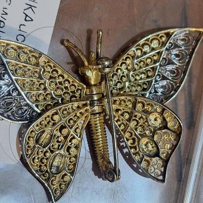 Sale Photo Thumbnail #1383: We can't find the marking for sterling but did find the AC marking.  This brooch is expected to be sterling silver .  The wings are hinged and will move.