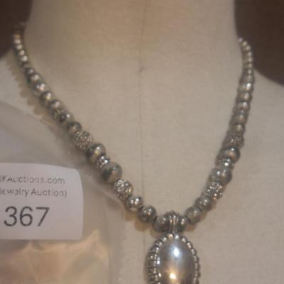 Sale Photo Thumbnail #1395: no markings to indicate metal info or artist info.