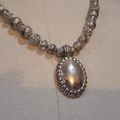 Sale Photo Thumbnail #1394: no markings to indicate metal info or artist info.