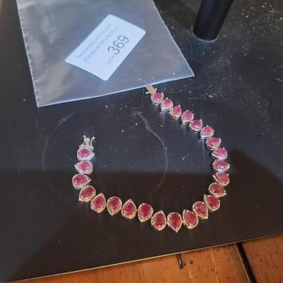 Sale Photo Thumbnail #1406: we could not read the markings- this has a safety latch like it might be sterling but the beads look to be lab created not precious gems.  See photos.