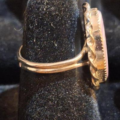 Sale Photo Thumbnail #1426: we are not sure what kind of stone this is, it looks more purple than pink- the lighting made some photos look pink.  It is sterling but the band is also adjustable so at it's smallest size it's just bigger than a 5.  We think this is Wampum shell and tha