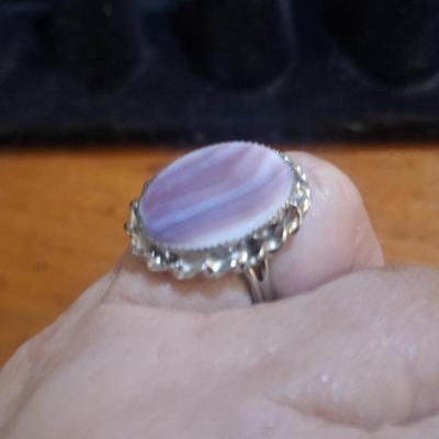 Sale Photo Thumbnail #1431: we are not sure what kind of stone this is, it looks more purple than pink- the lighting made some photos look pink.  It is sterling but the band is also adjustable so at it's smallest size it's just bigger than a 5.  We think this is Wampum shell and tha