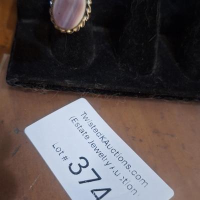 Sale Photo Thumbnail #1424: we are not sure what kind of stone this is, it looks more purple than pink- the lighting made some photos look pink.  It is sterling but the band is also adjustable so at it's smallest size it's just bigger than a 5.  We think this is Wampum shell and tha