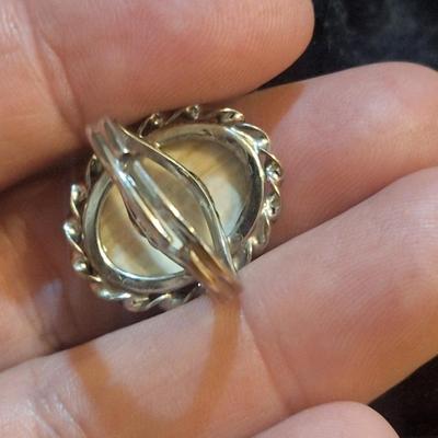 Sale Photo Thumbnail #1427: we are not sure what kind of stone this is, it looks more purple than pink- the lighting made some photos look pink.  It is sterling but the band is also adjustable so at it's smallest size it's just bigger than a 5.  We think this is Wampum shell and tha