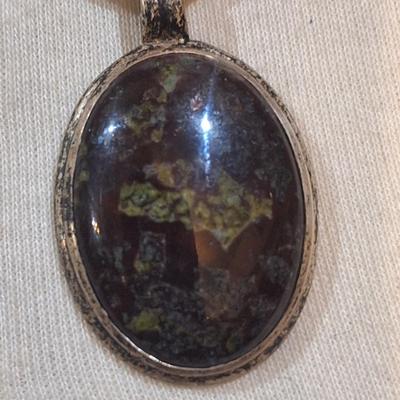 Sale Photo Thumbnail #1546: we are not sure what type of stone this is, the chain is marked 925, could not find a mark on the  pendant ,  please look over photos it also has a necklace extender which has no marking