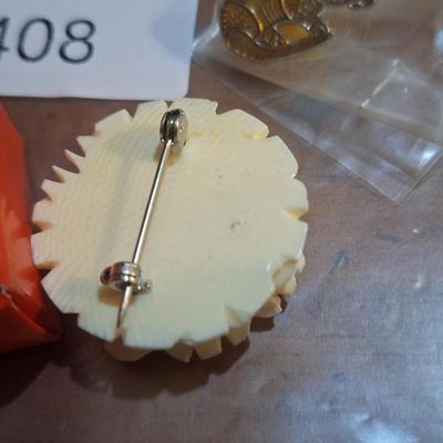 Sale Photo Thumbnail #1591: vintage jewelry, carved rose brooch, armadillo lapel pin and earrings.