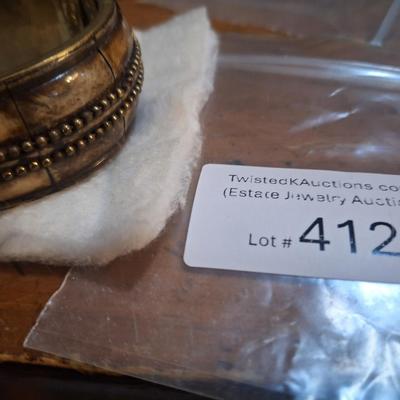 Sale Photo Thumbnail #1607: We can't figure out how to open it but it does look to be hinged.
looks like it might be camel bone.