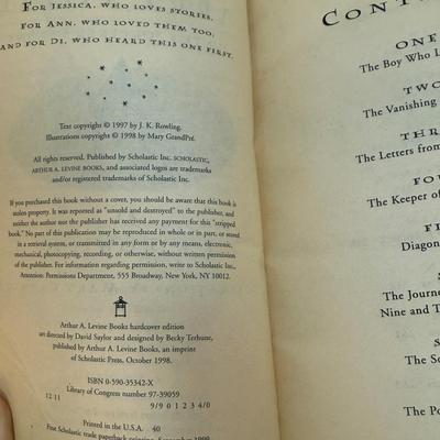 Sale Photo Thumbnail #205: Titles include: Harry Potter and the Sorcerer's Stone, Harry Potter and The Chamber of Secrets, and Harry Potter and The Prisoner of Azkaban.  One book has som pages curled up at the bottom corner, but are all otherwise in good, used condition.