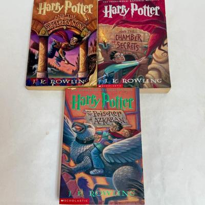 Sale Photo Thumbnail #206: Titles include: Harry Potter and the Sorcerer's Stone, Harry Potter and The Chamber of Secrets, and Harry Potter and The Prisoner of Azkaban.  One book has som pages curled up at the bottom corner, but are all otherwise in good, used condition.