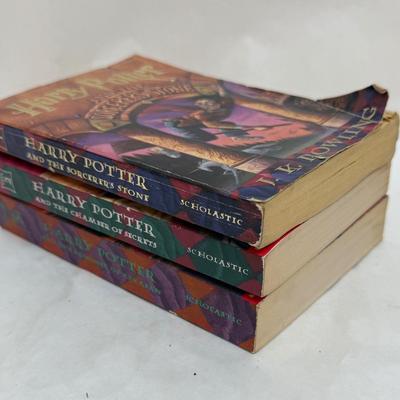 Sale Photo Thumbnail #201: Titles include: Harry Potter and the Sorcerer's Stone, Harry Potter and The Chamber of Secrets, and Harry Potter and The Prisoner of Azkaban.  One book has som pages curled up at the bottom corner, but are all otherwise in good, used condition.