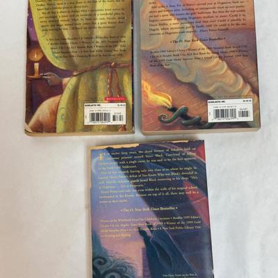 Sale Photo Thumbnail #202: Titles include: Harry Potter and the Sorcerer's Stone, Harry Potter and The Chamber of Secrets, and Harry Potter and The Prisoner of Azkaban.  One book has som pages curled up at the bottom corner, but are all otherwise in good, used condition.
