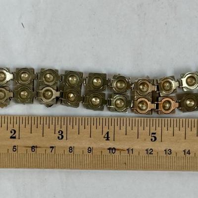 Sale Photo Thumbnail #78: Vintage Victorian Revival bracelet. This beautiful bracelet has two rows of square light gold tone (almost silver tone) base links. There are prong set glass rhinestones in colors of purple, light blue, green, orange, faux opal, light blue and faux pearl.