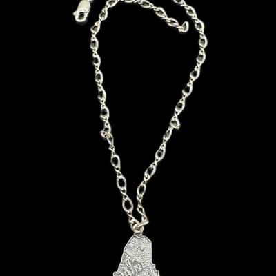 Sale Photo Thumbnail #832: **WIRE TRANSFER IS REQUIRED IF SHIPPED.** [34.72g] Includes a sterling marcasite ring, a sterling ankle bracelet with a State of Maine charm, and a South American panel bracelet in .900 silver. Total of three pieces. Measurement of longest: 10”. Age rel