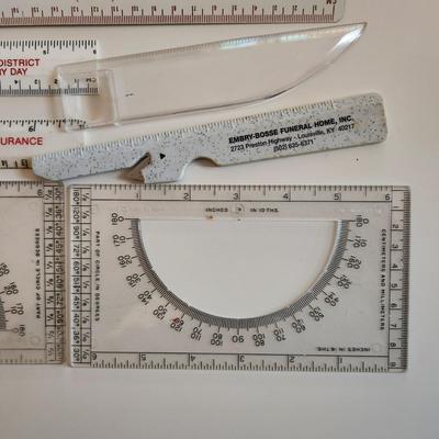 Sale Photo Thumbnail #341: This auction lot is for a Realm of Rulers.  These eight rulers can be both useful and collectible. The vintage Sturgeon rulers are metal, one ruler has a pencil sharpener, another has a magnifier and one is a letter opener.  A couple of protractors, too.