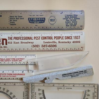 Sale Photo Thumbnail #344: This auction lot is for a Realm of Rulers.  These eight rulers can be both useful and collectible. The vintage Sturgeon rulers are metal, one ruler has a pencil sharpener, another has a magnifier and one is a letter opener.  A couple of protractors, too.