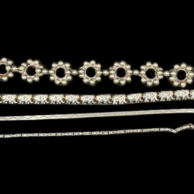 Sale Photo Thumbnail #845: **WIRE TRANSFER IS REQUIRED IF SHIPPED.** [31.85g] Includes an elephant chain bracelet, a Byzantine style bracelet, a herringbone bracelet, and more. Total of four pieces. Measurement of longest: 7.5”. Silver content confirmed using Niton XRF precious m