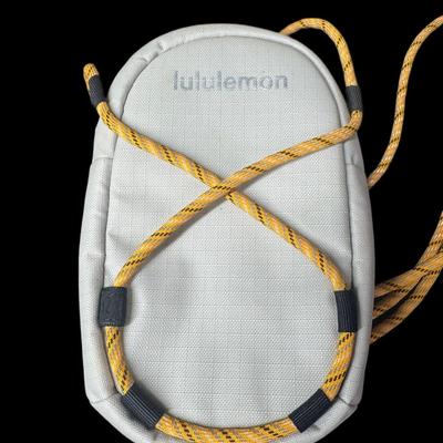 Sale Photo Thumbnail #881: Includes a Lulu Lemon crossbody wallet, a Coach bag, and a Dooney & Bourke bag. Total of three pieces. Age related wear. Measurement of largest: 13”. [CS]