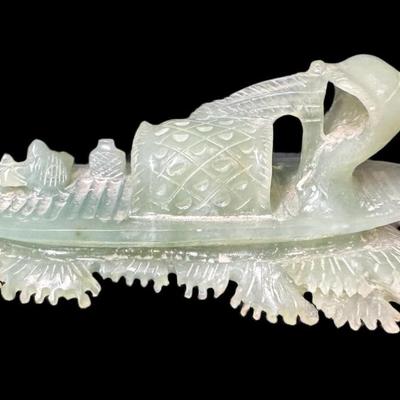 Sale Photo Thumbnail #887: Includes a carved jade fisherman, a Noah cow bell, a Robert De Niro signed painting, a Kaas Glassworks trinket dish, and more. Total of five pieces. Measurement of largest: 12”L. [CS]