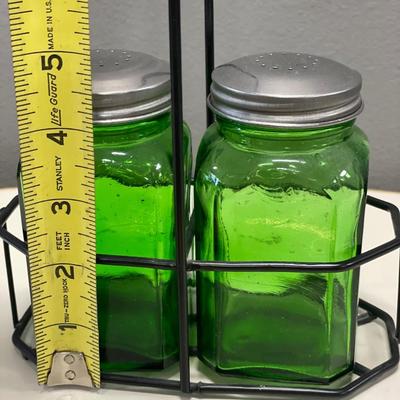 Green glass shakers in holder