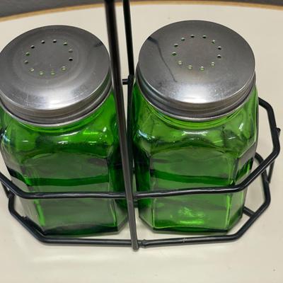 Green glass shakers in holder