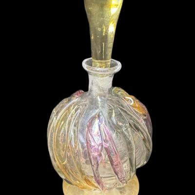 Sale Photo Thumbnail #891: This vintage piece is crafted from hand blown glass. It is signed on the base. The stopper is in original condition, and is unbroken. Measurement: 7”H. Pre-auction estimate: $100-$150. [CS]