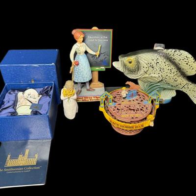 Sale Photo Thumbnail #906: Includes a Jim Beam crappie fish decanter, a cast iron mechanical horse bank, a Jim Shore Heartwood Creek statue, a Smithsonian Goebel tealight in the original box, and a Willow Tree Warm Embrace statue. Total of five pieces. Measurement of longest: 13”