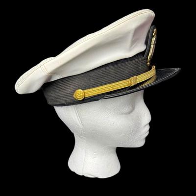 Sale Photo Thumbnail #912: This Naval white peak cap belonged to a master swimmer. The size is unmarked/unknown. Age related wear. Measurement: 11.75” Diameter. [CS]