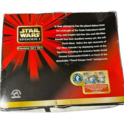 Sale Photo Thumbnail #915: Figures include Qui-Gon Jinn, Obi-Wan-Kenobi, and Darth Maul. Also includes an exclusive bonus piece, a battle droid. The box shows some storage related wear. Pre-auction estimate: $25-$50. [CS]