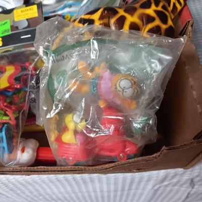 A BOX WITH A VARIETY OF TOYS