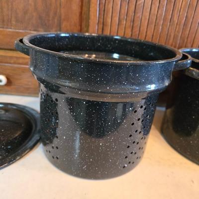 Two vintage speckled enamel stock pots with lids - small one has a strainer