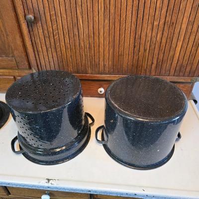 Two vintage speckled enamel stock pots with lids - small one has a strainer