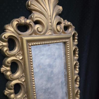 Homco Dart wall sconce with a smoked mirror and a gold-toned plastic frame. with angels - gold cherub or putto.wall art and vintage gold...