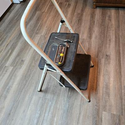 Stepstool with small tools and a box of assorted cords and a nice power supply usb box