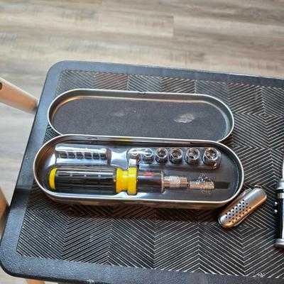 Stepstool with small tools and a box of assorted cords and a nice power supply usb box