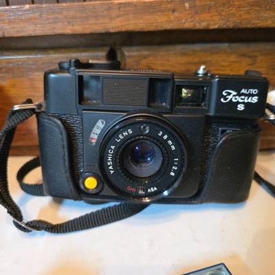 Yashica Auto Focus S 35mm point-and-shoot film camera with an assortment of vintage Sylvania Flashbars and Flashcubes for specific...