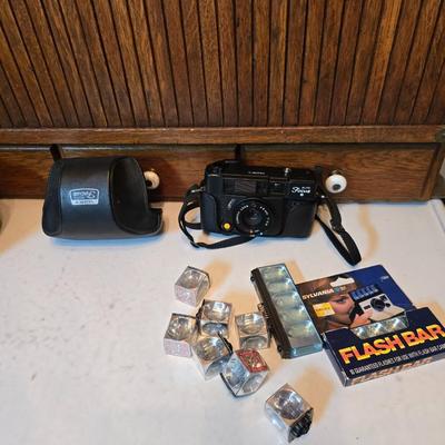 Yashica Auto Focus S 35mm point-and-shoot film camera with an assortment of vintage Sylvania Flashbars and Flashcubes for specific...