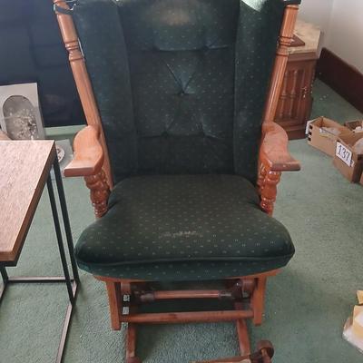 Wooden cane back glider with green cushions - a small table and an antique wooden stool