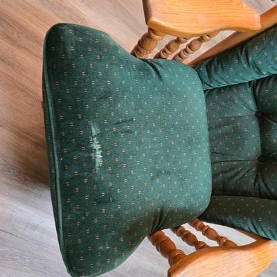 Wooden cane back glider with green cushions - a small table and an antique wooden stool