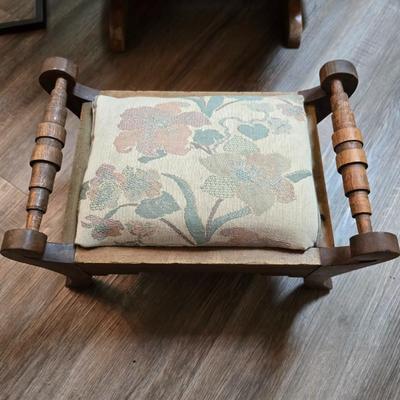 Wooden cane back glider with green cushions - a small table and an antique wooden stool
