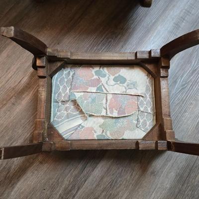 Wooden cane back glider with green cushions - a small table and an antique wooden stool