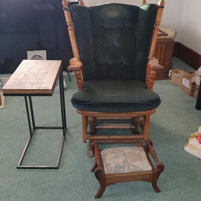 Wooden cane back glider with green cushions - a small table and an antique wooden stool