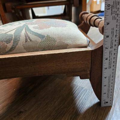 Wooden cane back glider with green cushions - a small table and an antique wooden stool