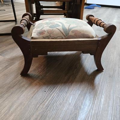 Wooden cane back glider with green cushions - a small table and an antique wooden stool