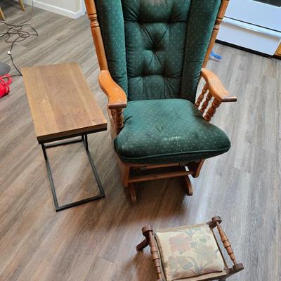 Wooden cane back glider with green cushions - a small table and an antique wooden stool