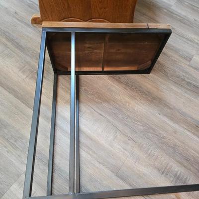 Wooden cane back glider with green cushions - a small table and an antique wooden stool