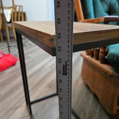 Wooden cane back glider with green cushions - a small table and an antique wooden stool