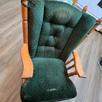 Wooden cane back glider with green cushions - a small table and an antique wooden stool